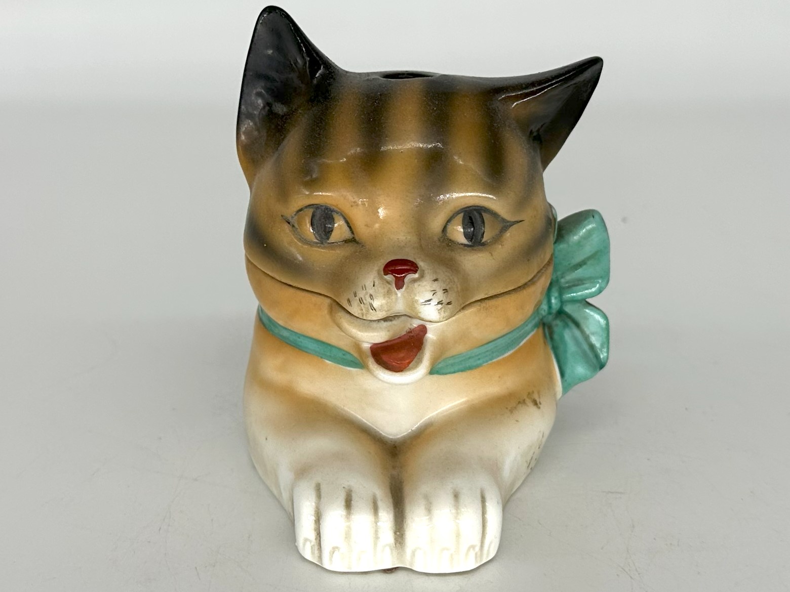 Porcelain Cat with a Green Bow