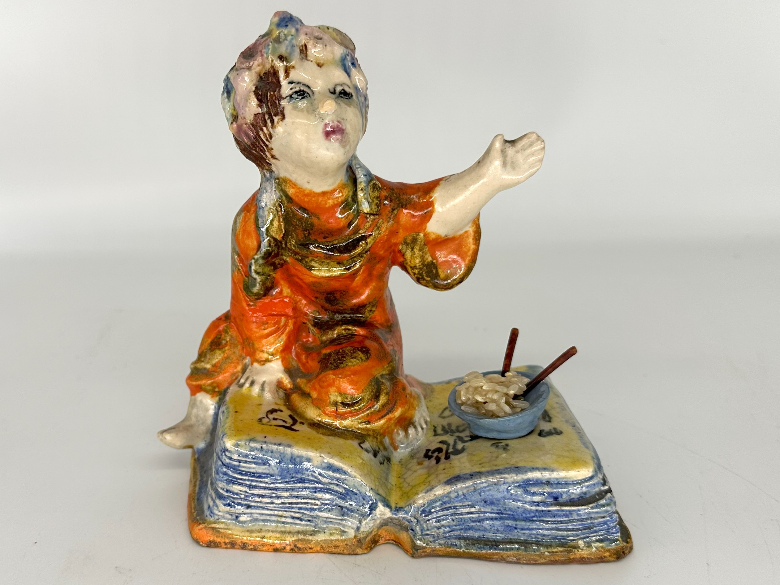 Oriental Girl Kneeling on a Book