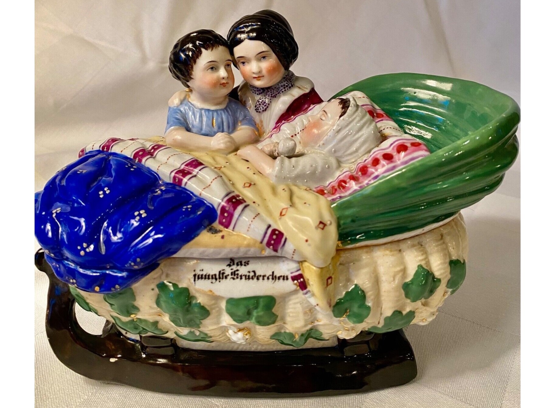 Siblings with Baby in a Cradle