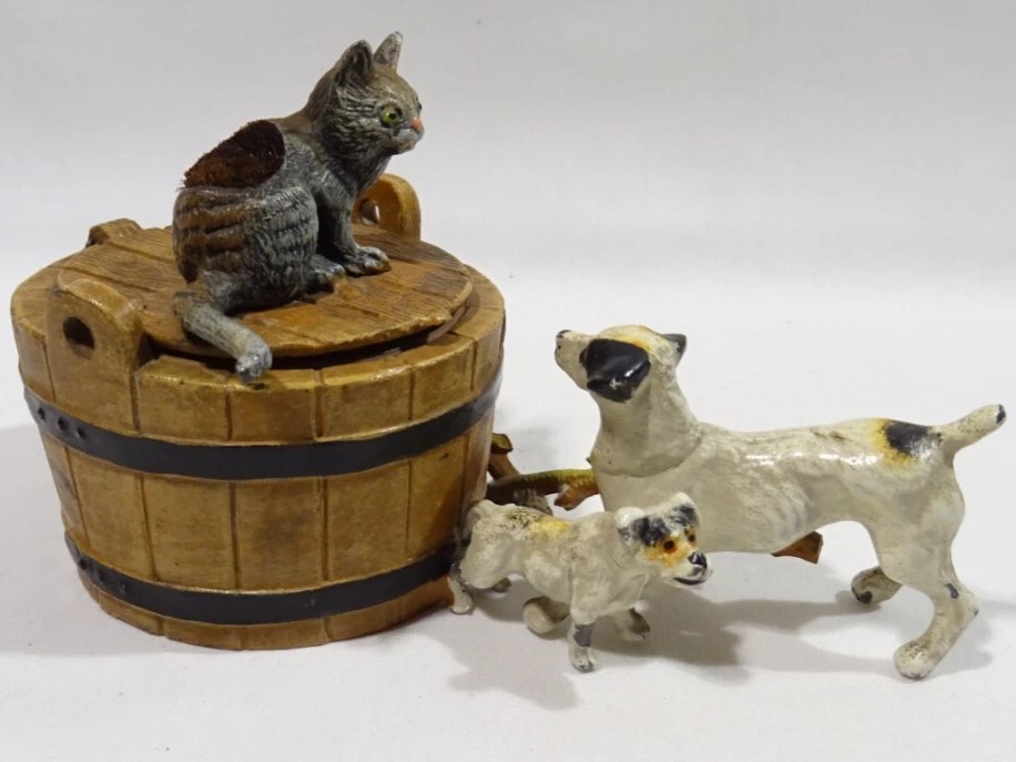 Two Dogs Encounter a Cat on a Barrel